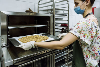 Midsection of woman preparing food in kitchen