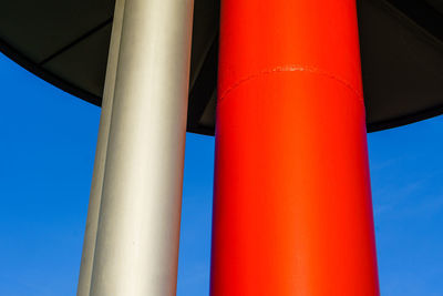 Low angle view of blue pipe against sky