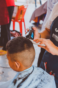 Boy getting haircut at salon