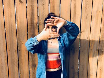 Midsection of man standing on wood