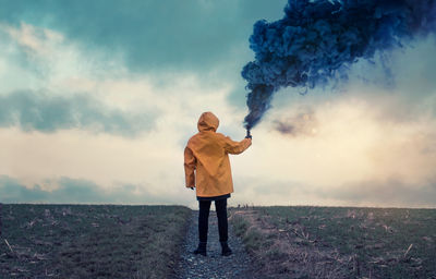 Full length of a man standing on landscape against sky