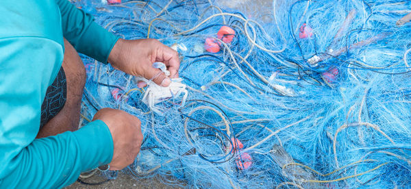 The fisherman takes a crab from the fisherman net, preparing to sell at the seafood market.