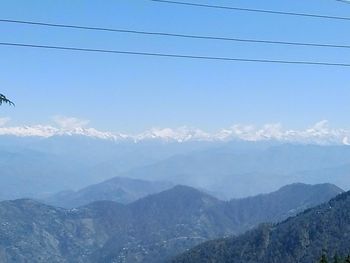 Scenic view of mountains against blue sky