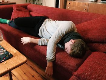 Young man sleeping on sofa at home