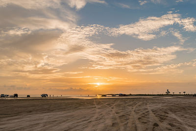 Scenic view of beach against sky during sunset