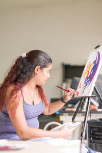 Young woman using laptop at home