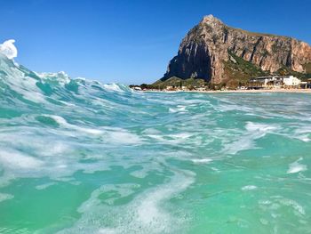 Scenic view of sea against clear blue sky