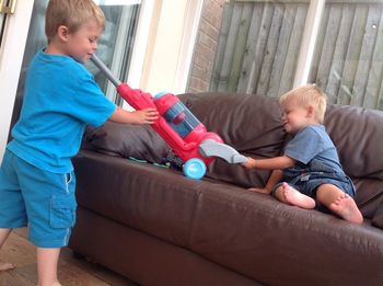 Boys playing on couch