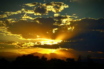 Low angle view of silhouette mountains against sky during sunset