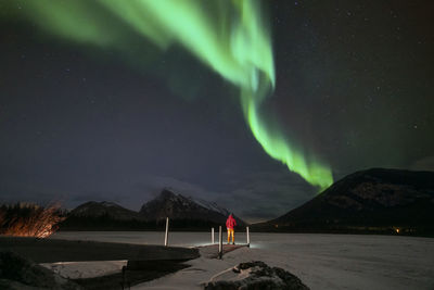 Scenic view of snowcapped mountains against sky at night