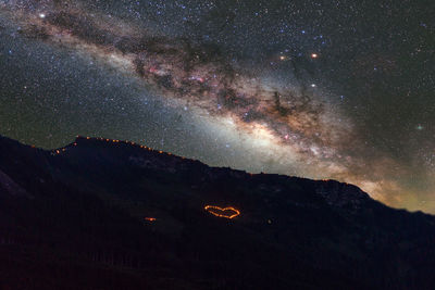 Aerial view of mountains against sky at night