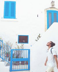 Full length of man standing against building