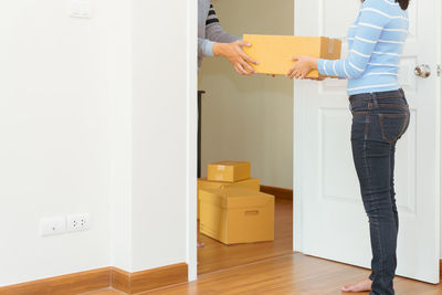 Low section of woman standing at home