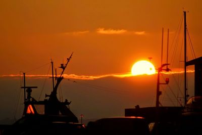 Boats at harbor during sunset