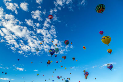 Low angle view of hot air balloons flying in sky