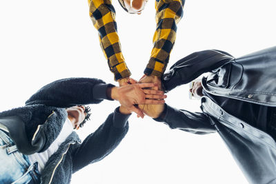 Young men and woman stacking hands