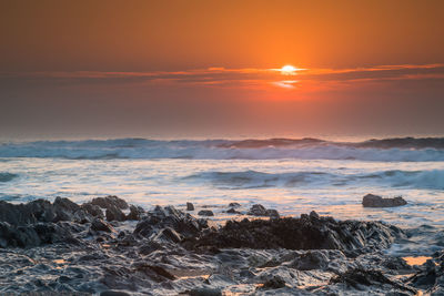 Scenic view of sea against sky during sunset