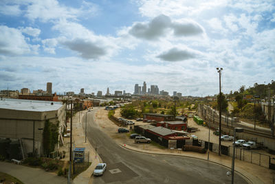 High angle view of city street and buildings against sky