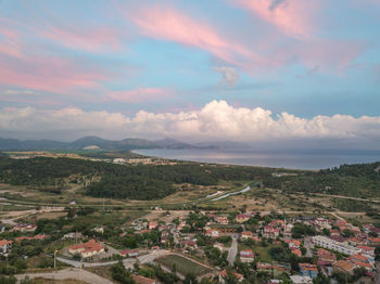 High angle view of townscape by sea against sky