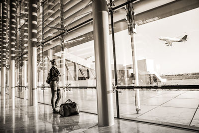 Rear view of man cycling at airport