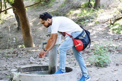 Side view of young man standing on land