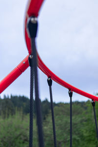 Low angle view of play equipment at playground against cloudy sky