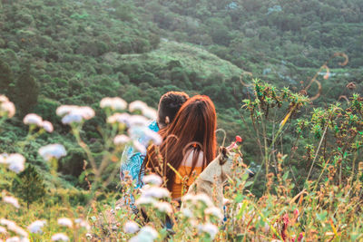 Rear view of woman walking on field