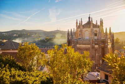 Panoramic view of trees and buildings against sky