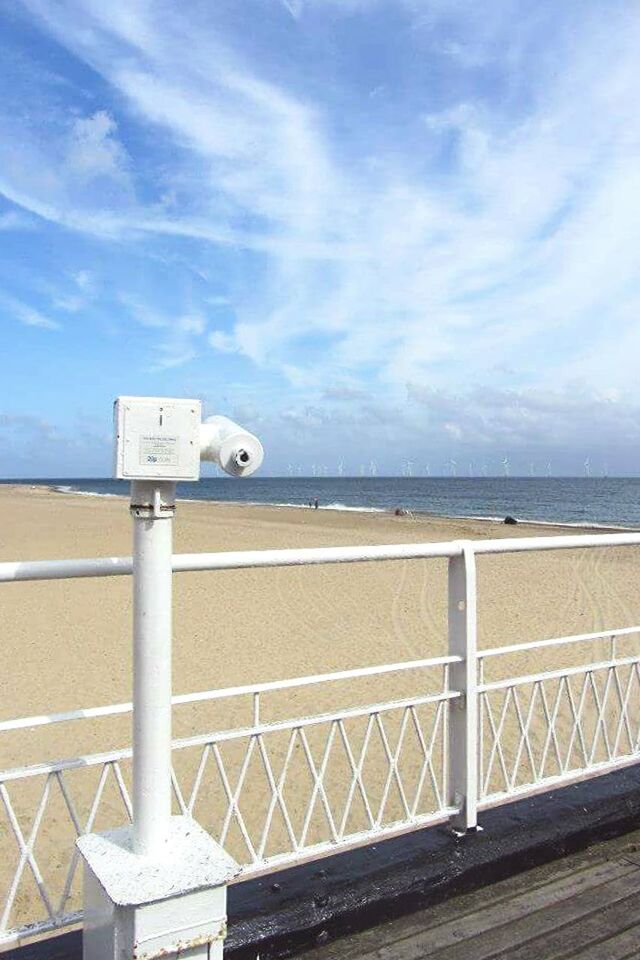 VIEW OF LIFEGUARD TOWER AGAINST CLOUDY SKY