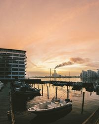 Boats in harbor at sunset