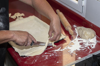 Midsection of man preparing food in kitchen at home