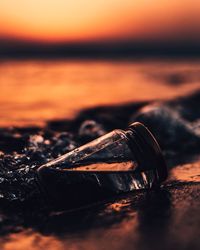 Close-up of water against sky at sunset