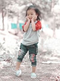 Smiling girl standing on field