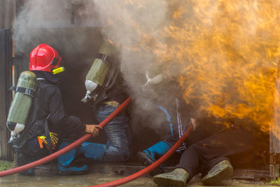 Firefighter, fire a strong and brave firefighter injects water against the fierce fire.