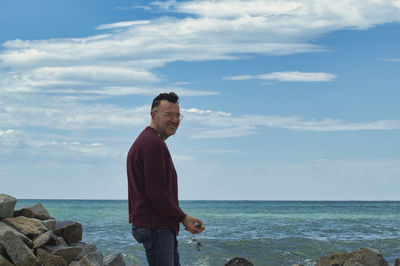 Lonely man on the seashore looking at camera