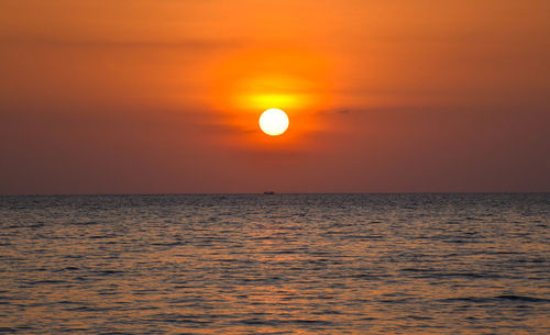 Scenic view of sea against orange sky