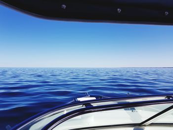 Close-up of car on sea against blue sky