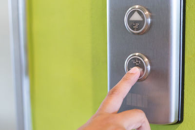 Close-up of hand on green door