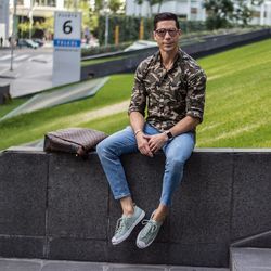 Full length of young man sitting on grass