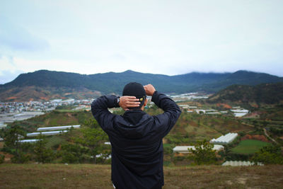 Full length of man standing on mountain against sky