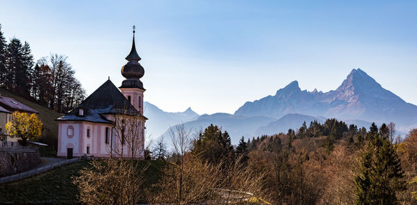 Panoramic view of trees and buildings against sky