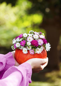 Midsection of woman holding bouquet