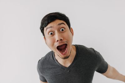 Portrait of young man against white background