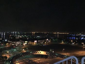 High angle view of illuminated buildings against sky at night