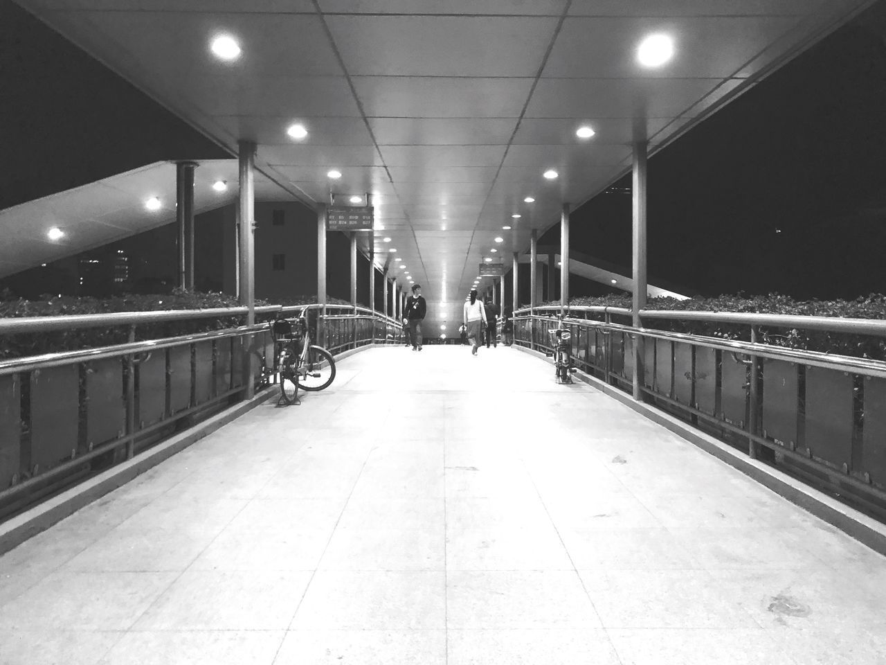 VIEW OF ILLUMINATED EMPTY UNDERGROUND WALKWAY