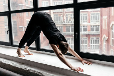 A man with strong body engaged in yoga and meditation, performing asanas