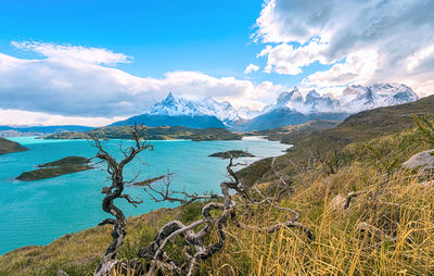 Scenic view of sea and mountains against sky