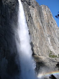 Low angle view of waterfall against sky