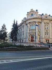 Street by building against sky