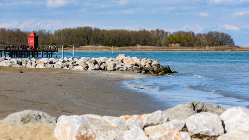 View of rocks on beach against sky